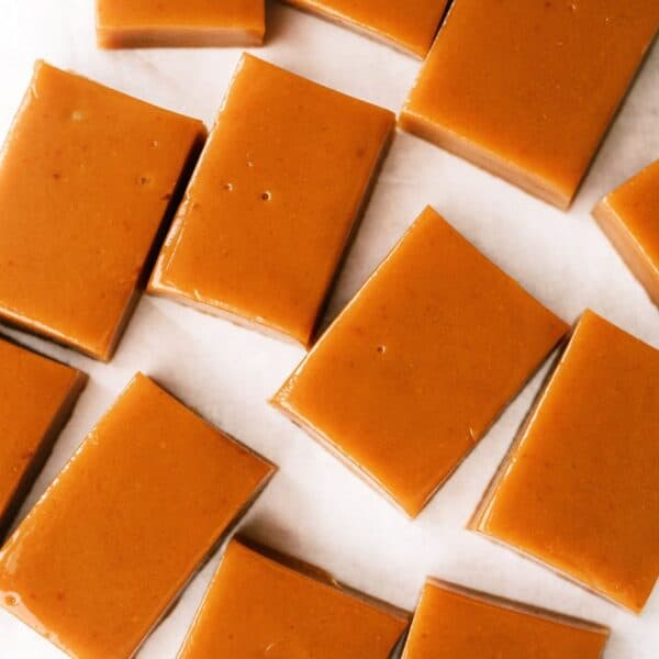 Homemade Caramels cut into rectangles and separated on a counter top.