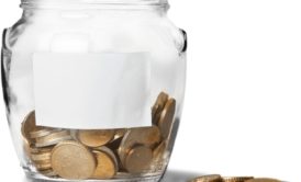 clear glass jar filled with bronze coins