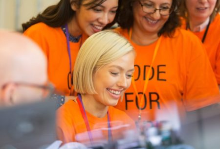 female nonprofit workers wearing orange uniform