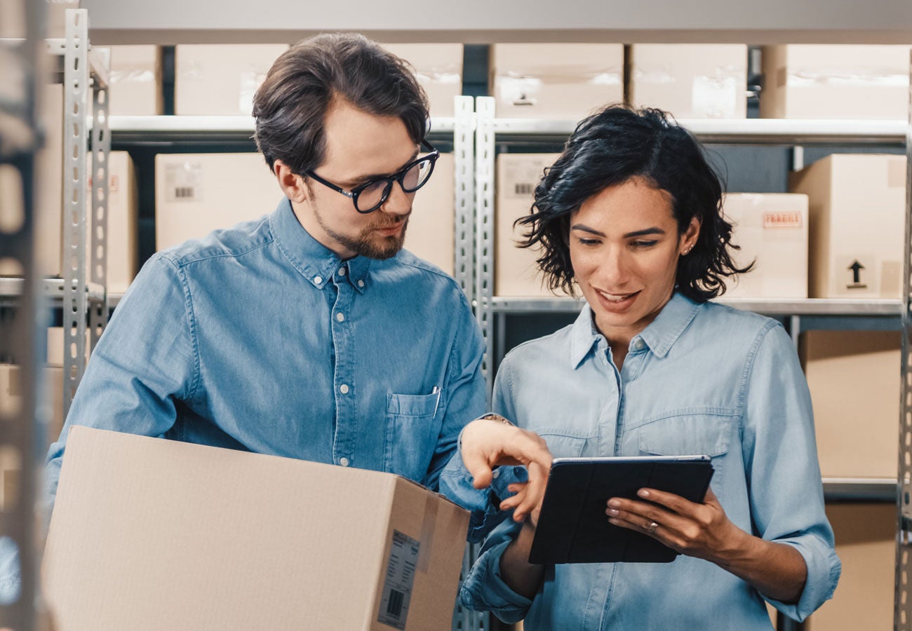 Two people working together in a warehouse.