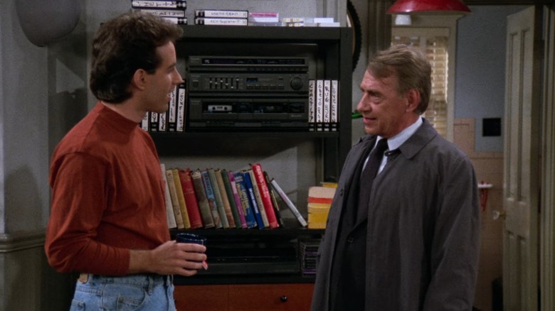 Jerry Seinfeld and Philip Baker Hall's Bookman face each other while talking in Jerry's apartment on Seinfeld