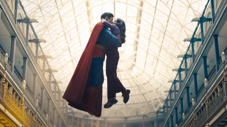 David Corenswet as Superman and Rachel Brosnahan as Lois Lane kissing while suspended in mid-air in Superman