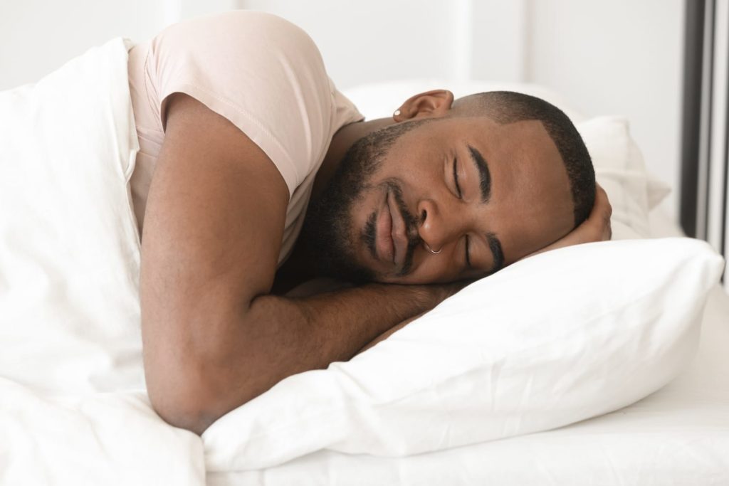 man sleeping in bed