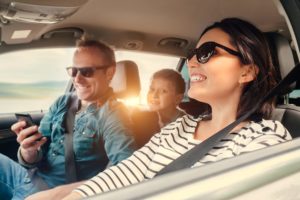 Happy family riding in a car