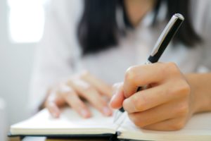 Woman writing in notebook