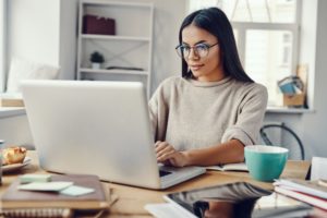 Woman working at home with a coffee