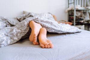 Feet sticking out from a comforter