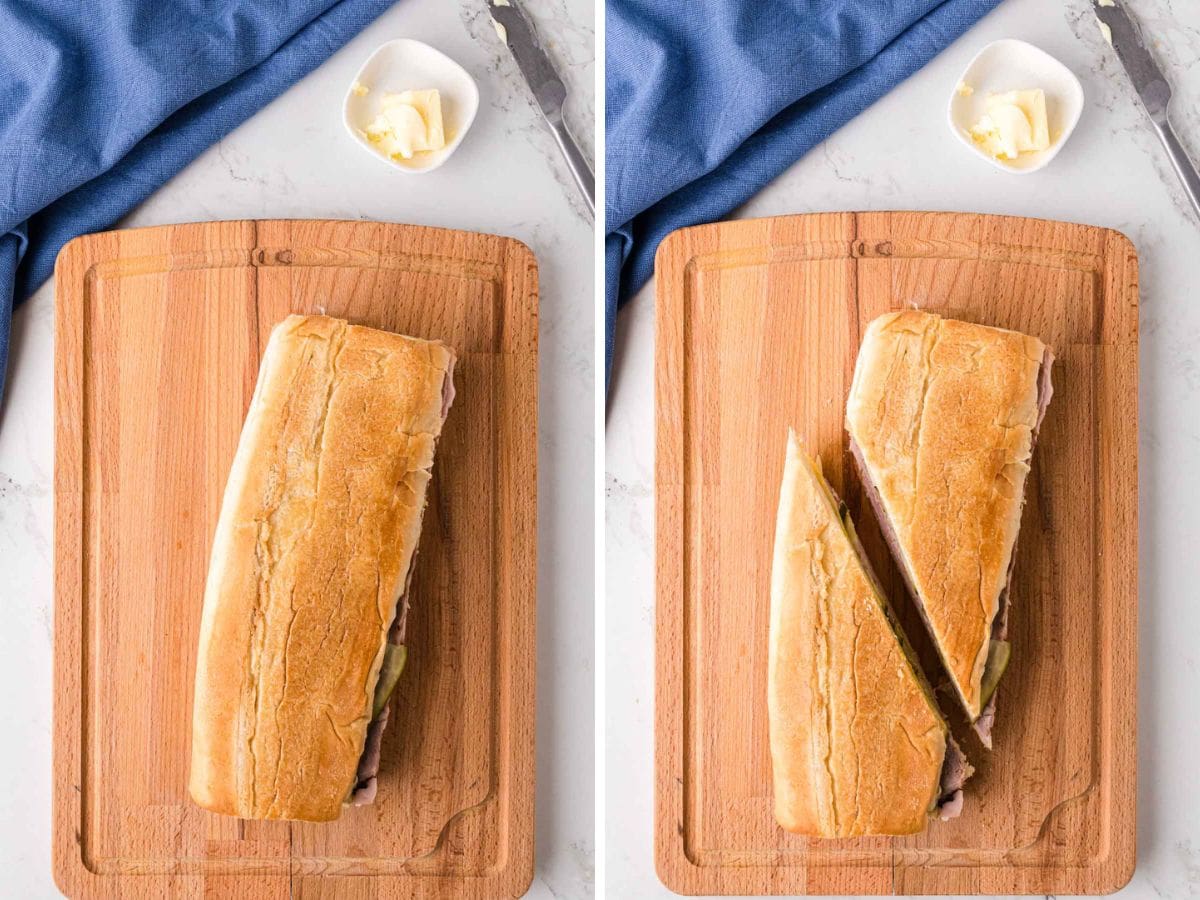 Cuban Sandwich sliced in half on a cutting board.