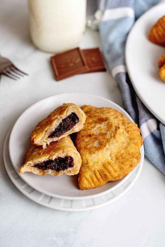 Chocolate fried pie broken in half to show filling.