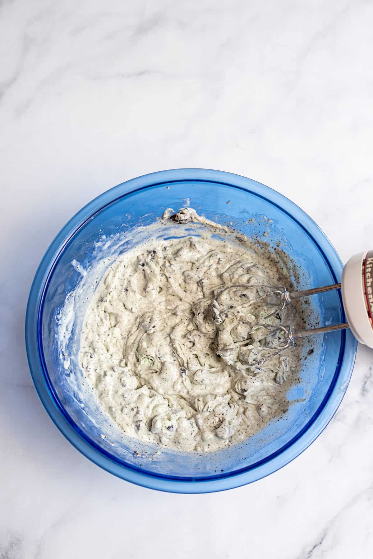 Mixed ingredients in blue mixing bowl.