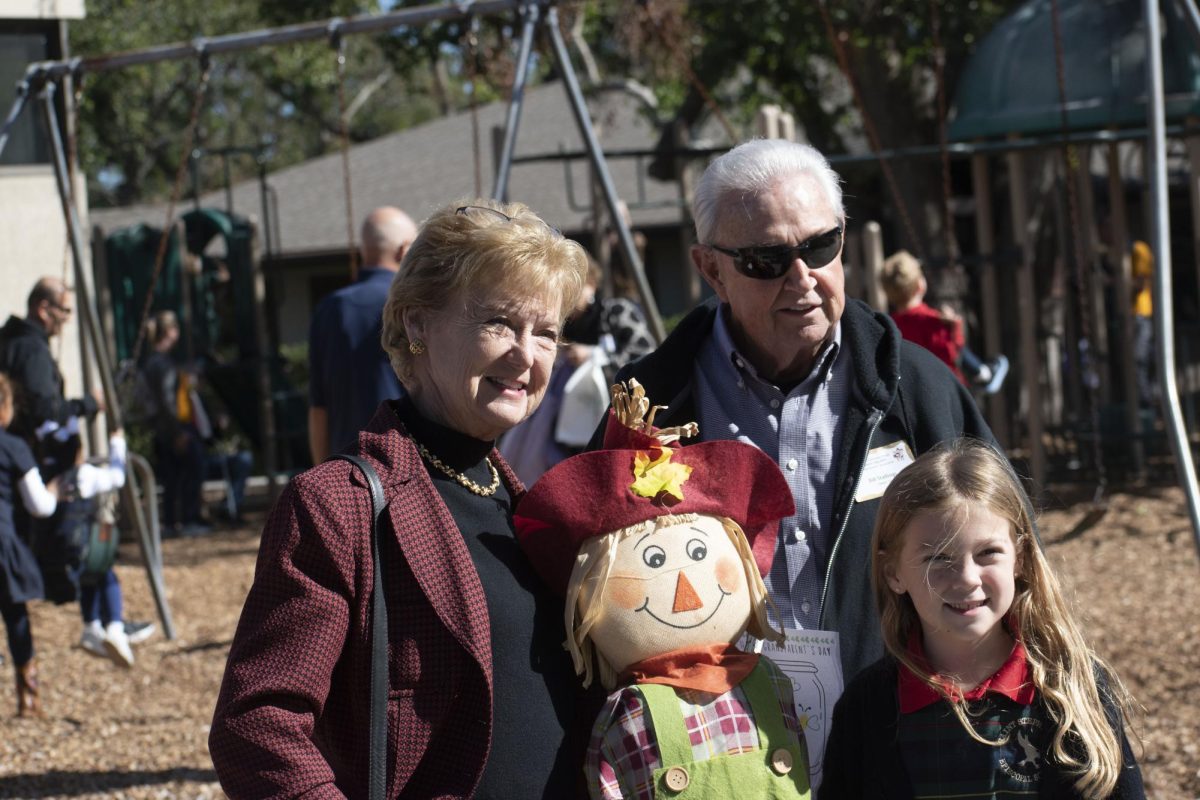 Grandparents and their grandchild flash a smile for a fun Grandparent's Day picture.