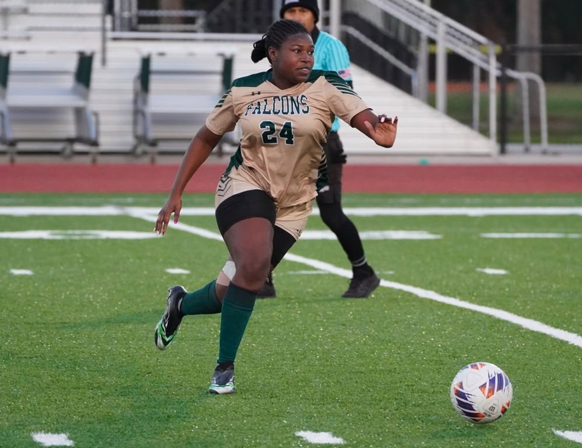 Senior Abigail Rogers attacks the ball during a match of soccer. 