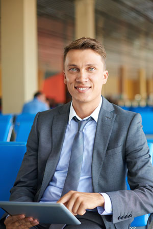 Business man on the go in airport lounge
