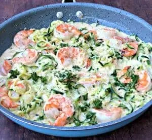 low carb zucchini alfredo in cream sauce in a skillet