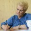 Woman Writing a Heartfelt Sympathy Card