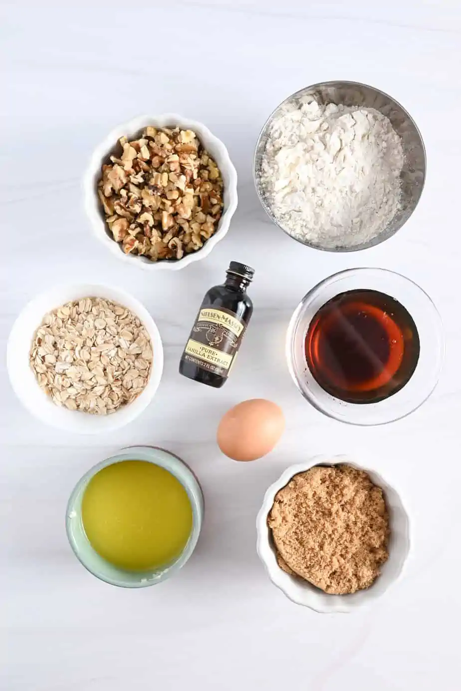 Ingredients for maple walnut blondies arranged on a marble counterop.