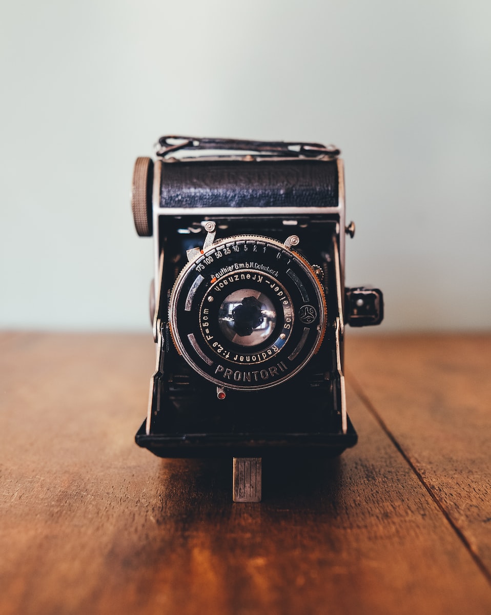 black Prontor II camera on brown wooden board