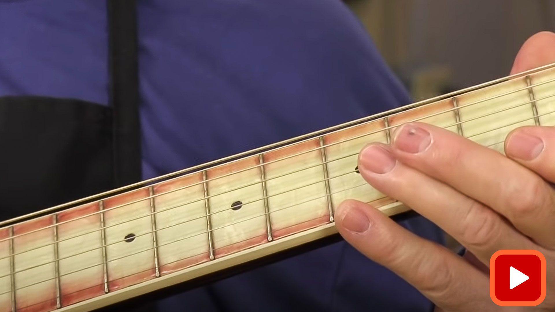 Hand showing buzzing fret on fingerboard