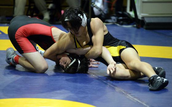 Kadena's Kai Espiritu gains the upper hand on Kinnick's Juno Robinson in the 127-pound final, won by Espiritu.