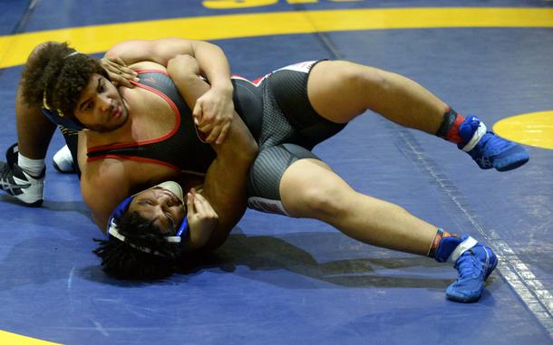 E.J. King's Jesus Puello locks in a head-and-arm hold on Kadena's Richard Gantz in the heavyweight final, won by Puello.