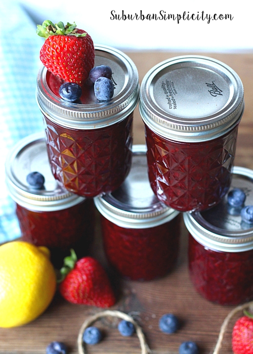 Five mason jars of canned triple Berry Jam. 