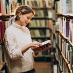 woman browsing books to build her library