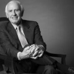 headshot of Jim Rohn posing on a chair