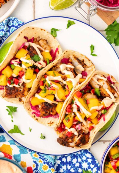 Overhead photo of three tacos on a plate.