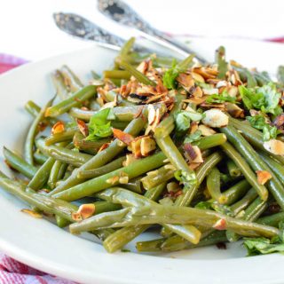 AUTHENTIC FRENCH GREEN BEAN recipe from my mum sauteed in olive oils with almonds, shallots, garlic and deglazed with lemon juice. An easy side dish for Holidays, Christmas or Thanksgiving. Dairy free + gluten free + vegan.