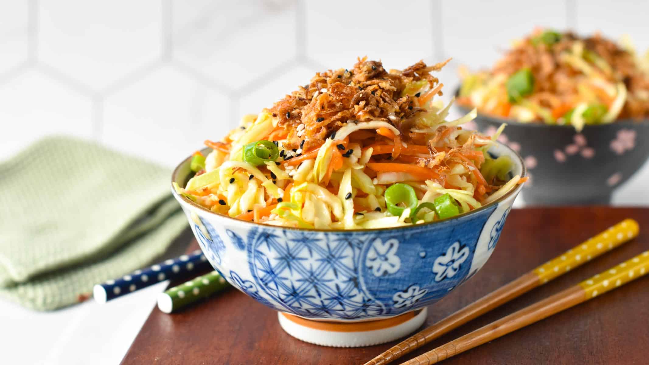 a bowl of Japanese cabbage salad topped with fried shallots