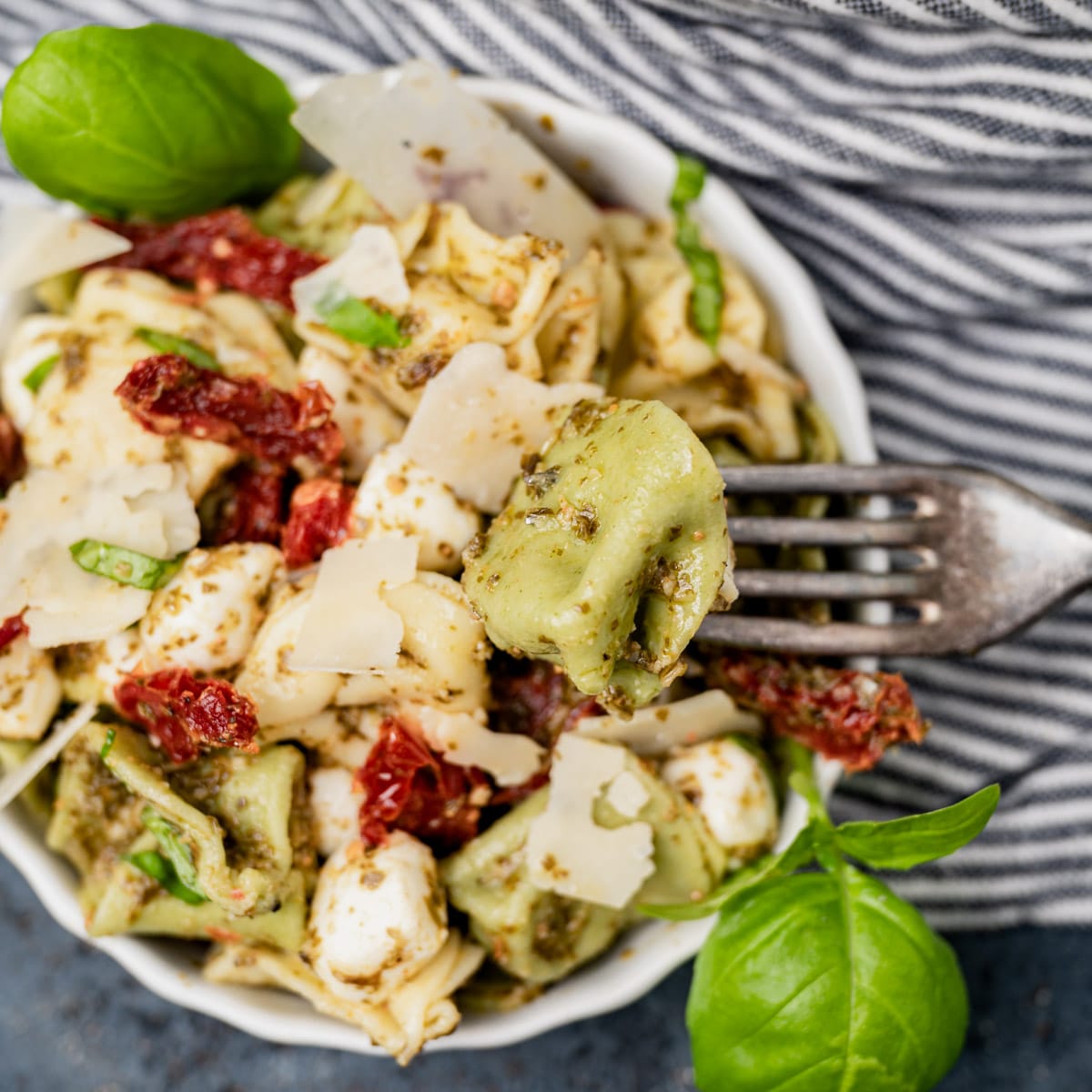 overhead shot of a bowl of pesto pasta salad with a fork