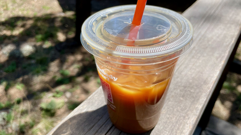 Iced coffee on wooden railing