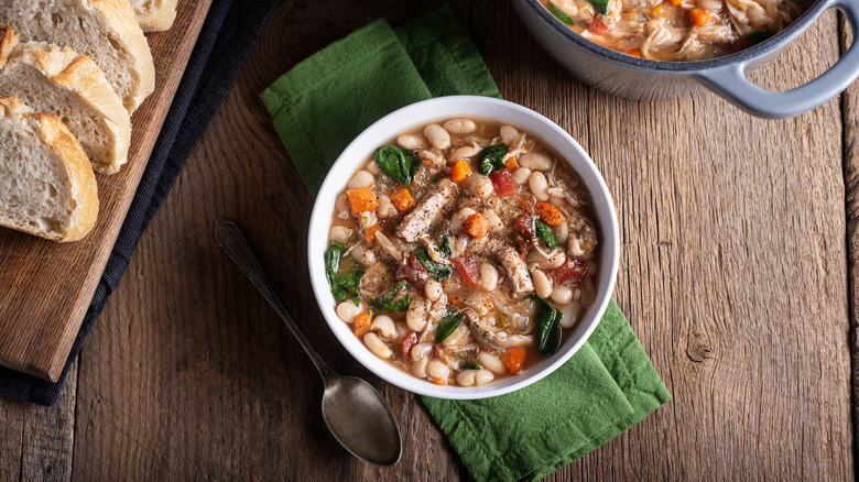 Bean soup in bowl on wood board 