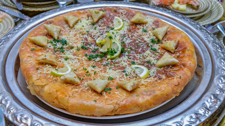 pastilla with lemon and herb garnish