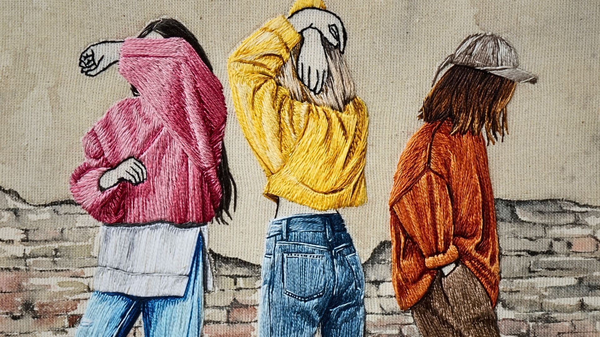 A stitched artwork of three women wearing bright coloured clothes