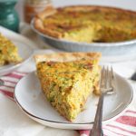 slice of broccoli cheese quiche on plate