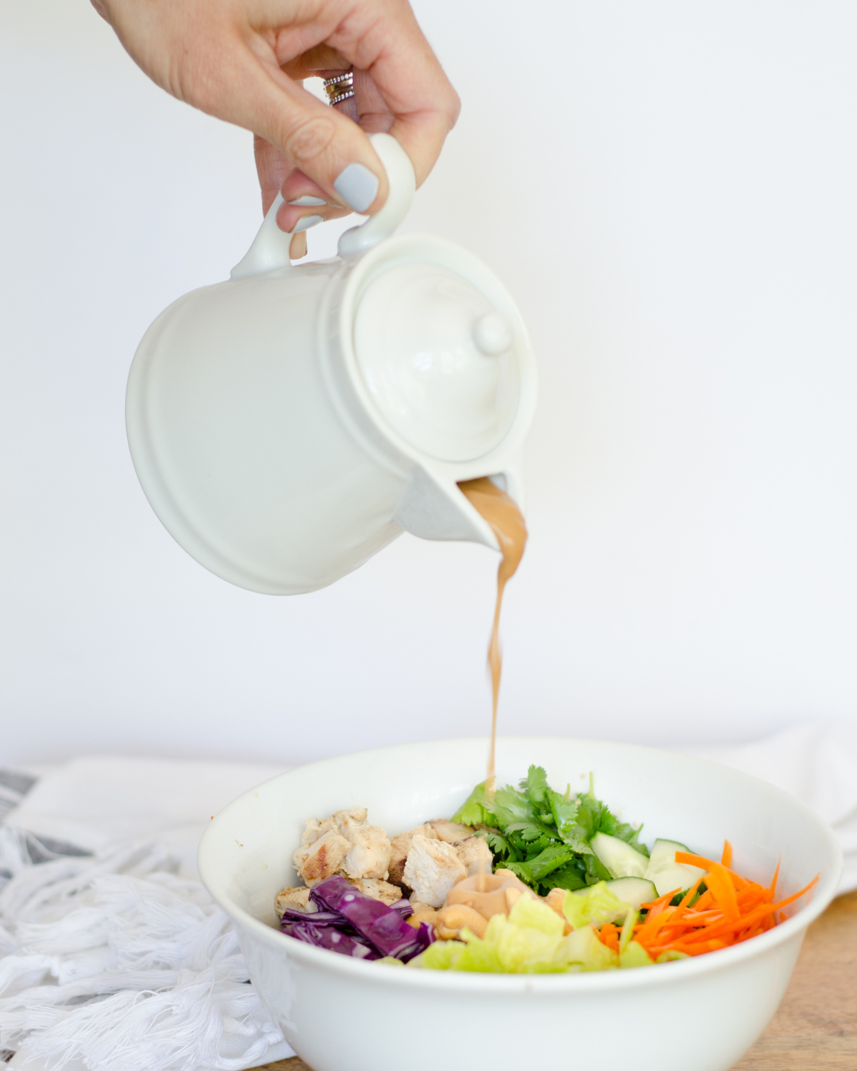 Thai chicken bowls - like thai lettuce wraps in a bowl! Loaded with veggies and topped with a nutty, creamy dressing. Paleo and Whole 30 recipe.