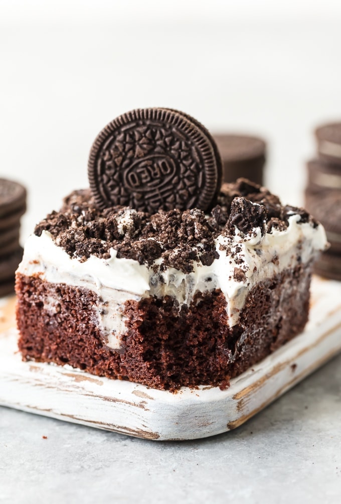 oreo poke cake with a bite out of the corner