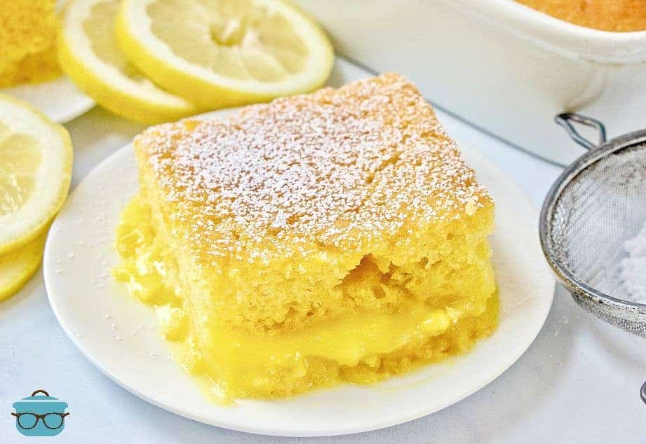 slice, Lemon Lava Cake on a white plate served with powdered sugar