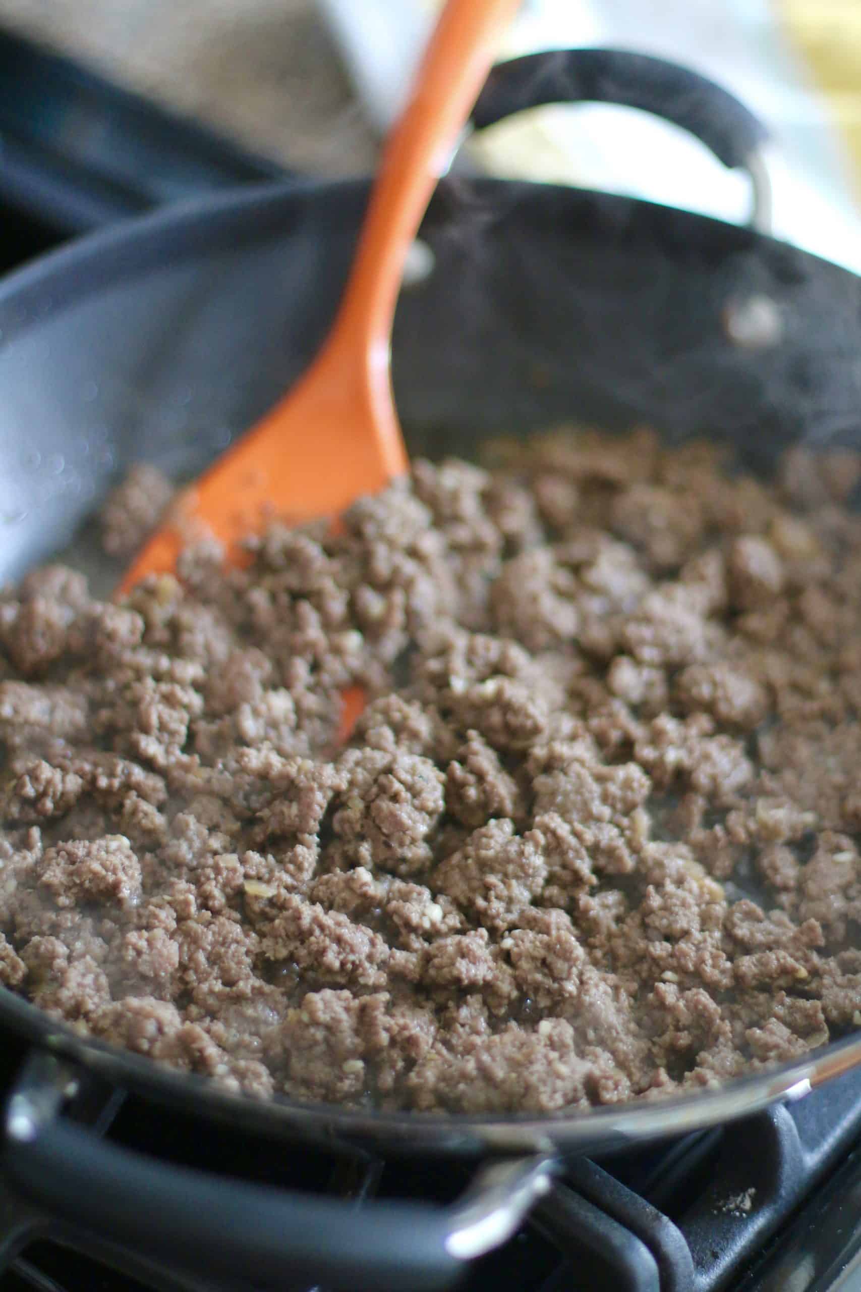 browning and crumbling ground beef in a large skillet.