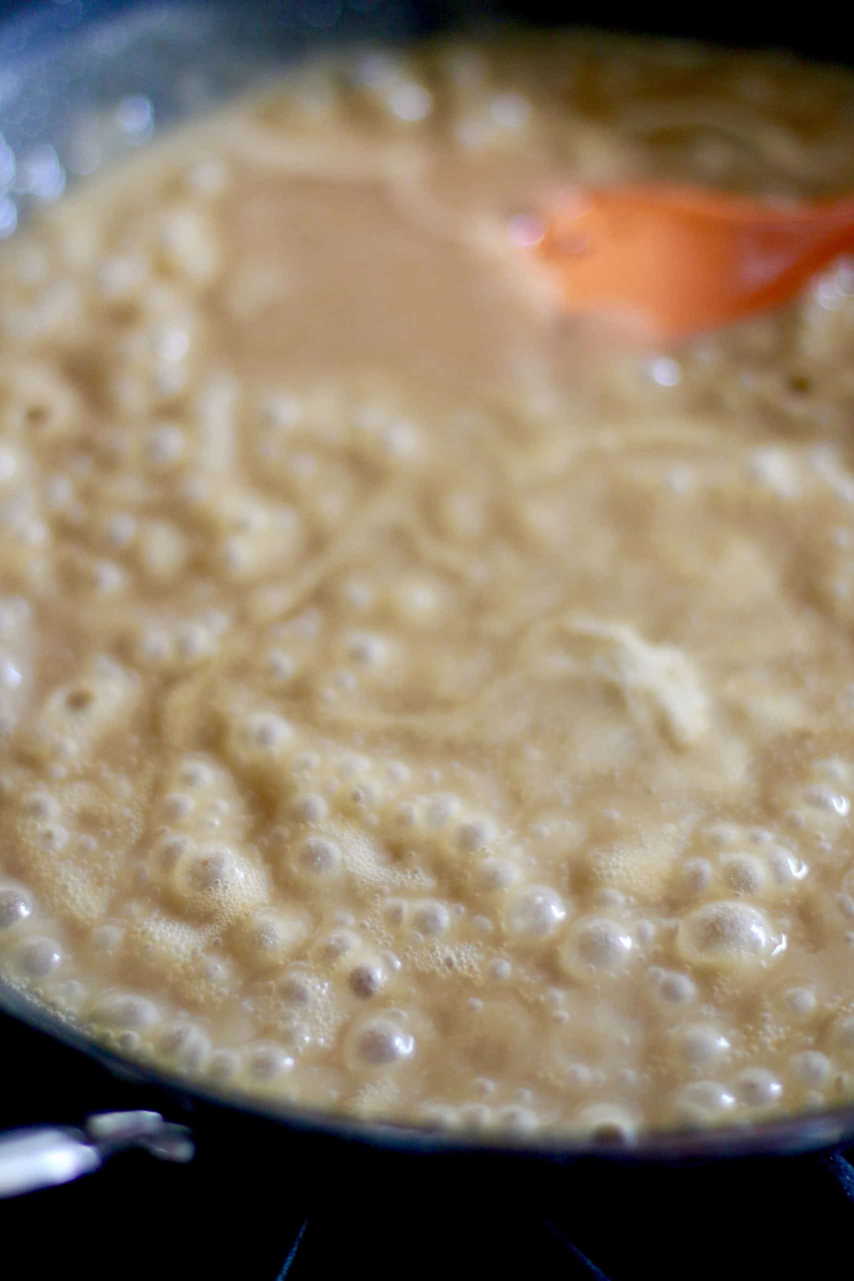 beef broth added to roux, heat turned to high to thicken in a skillet with a spoon.