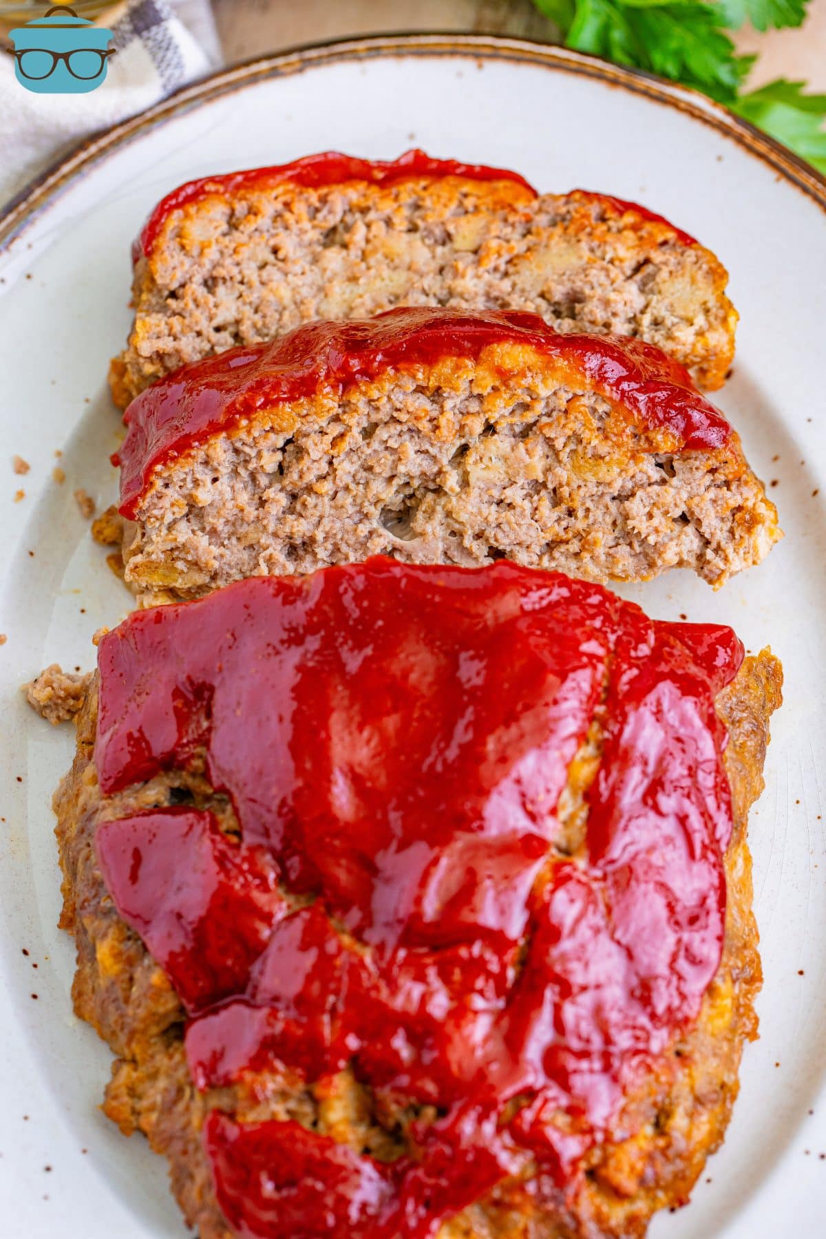 A loaf of Momma's Meatloaf with a few slices cut off laying on their sides.