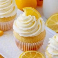 Square image of close up of one Homemade Lemon Cupcake with lemon wedge