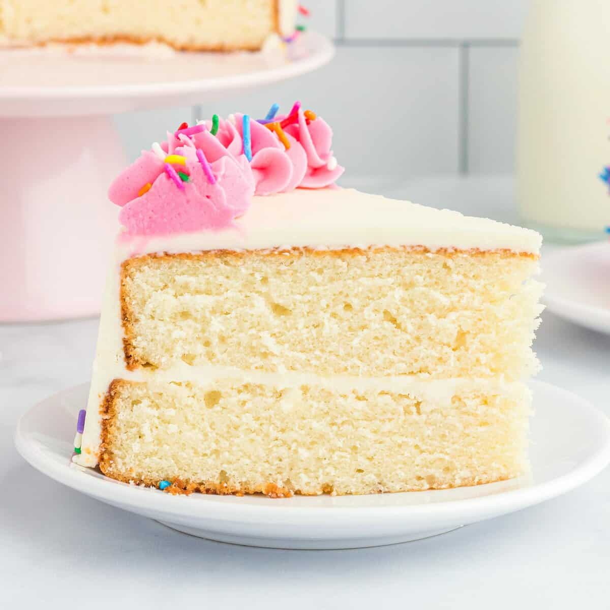 A decorated slice of homemade white cake on a plate.