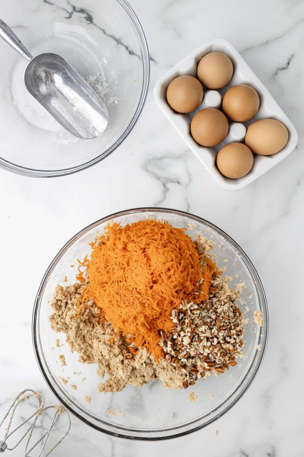 Grated carrots on a carrot cake cookie dough.