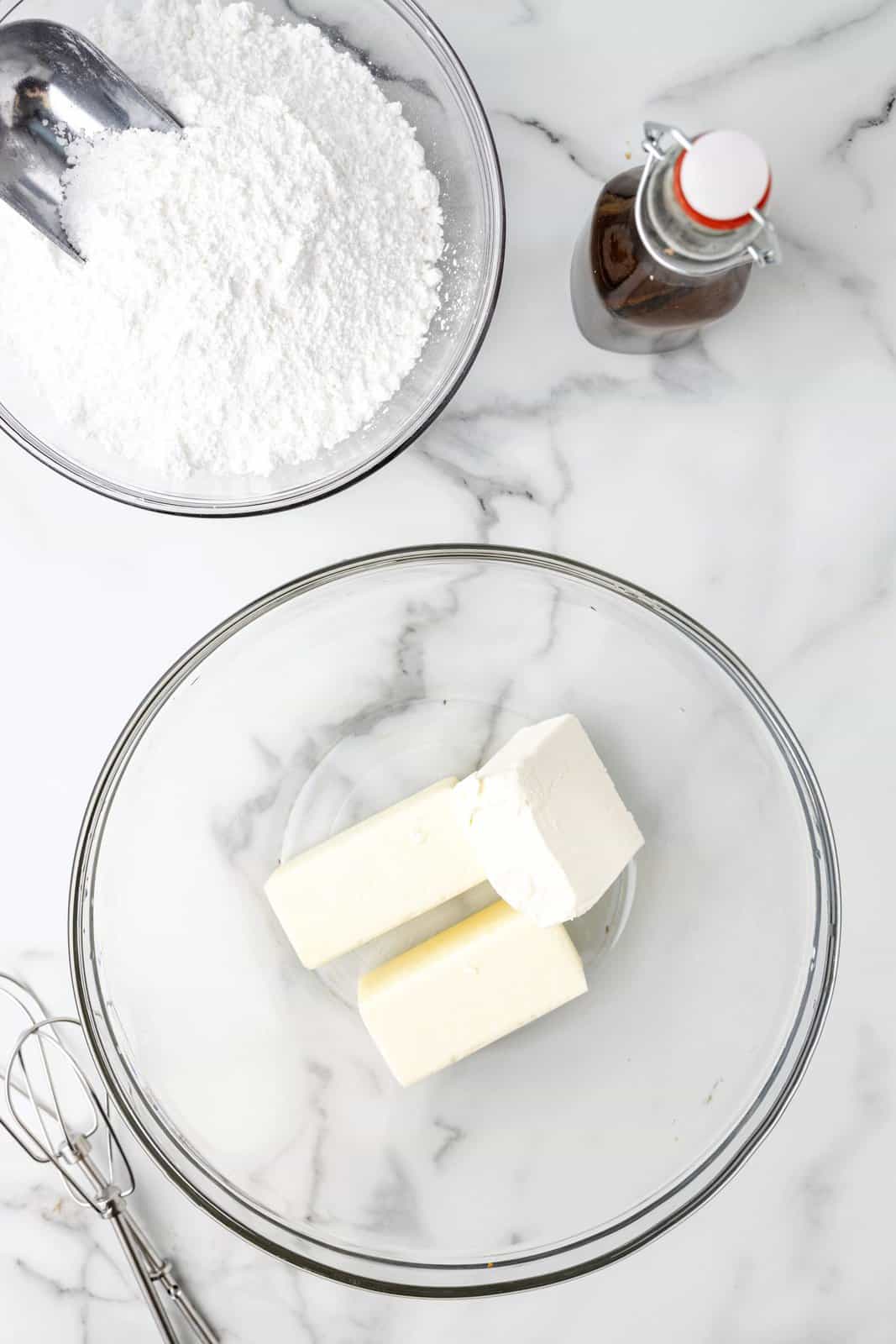 A mixing bowl with butter and cream cheese.