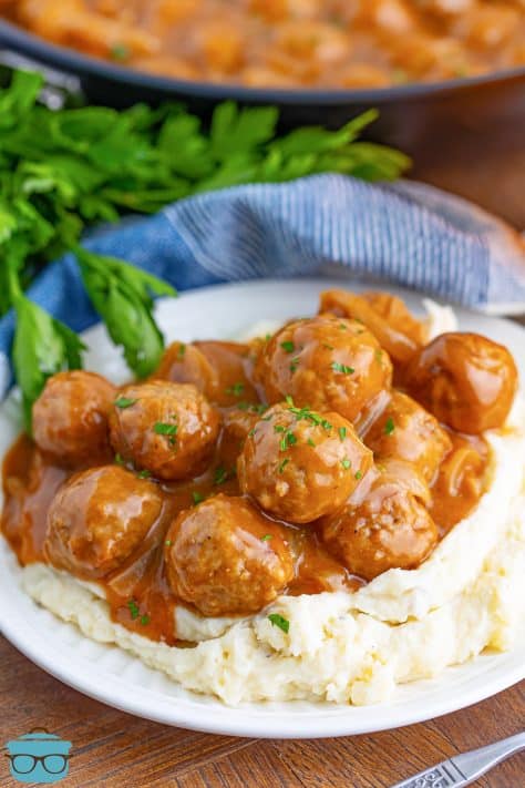 A plate of Salisbury Steak Meatballs on top of mashed potatoes.