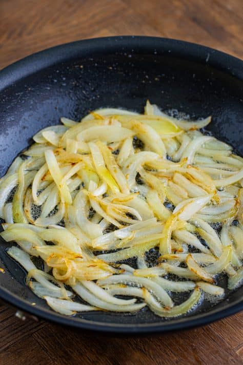 sliced onions in a skillet.