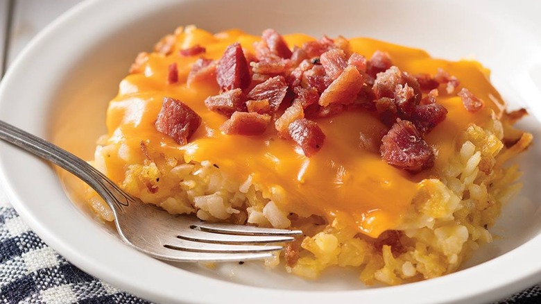 loaded hash brown casserole on plate with fork