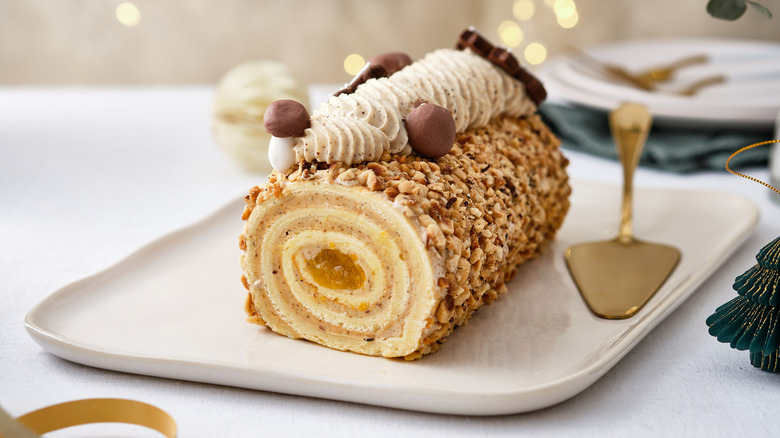 Christmas cake Bûche de Noël on a festive background